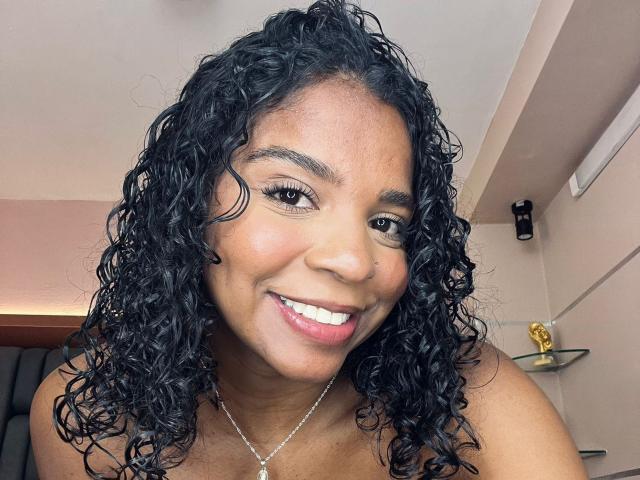 A digital illustration of a black and white coat of arms with a red and white background. The coat of arms features a black, stylized design in the center.