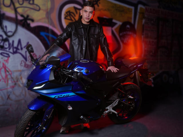 Digital illustration of a red and blue Soviet-style hammer and sickle emblem with a red star in the center. Simple, flat colors. Minimalistic design. Bold, symmetrical composition.