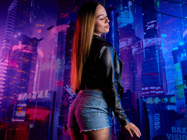 LinaMillia with long brown hair, leather jacket, and denim shorts, standing with eyes closed, showing off her ass. Neon lights and cyberpunk background. She's cute and sexy.