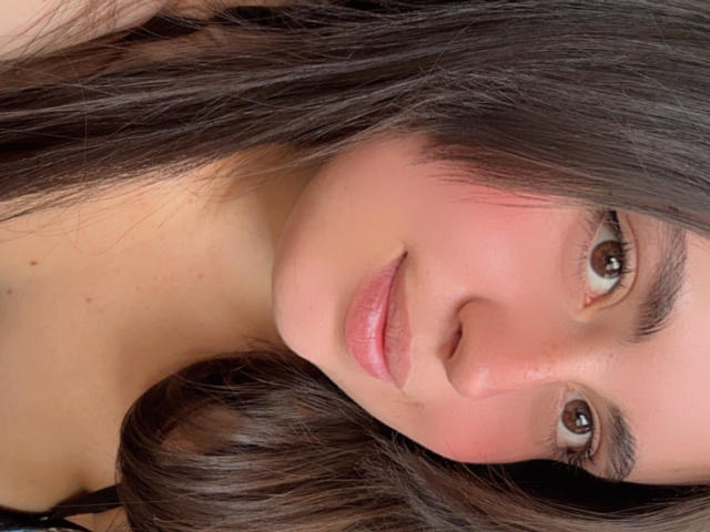 VicluX has brown eyes, pinkish cheeks, and shiny brown hair, with slightly parted pink lips. She's looking at the camera with a gentle, relaxed expression.