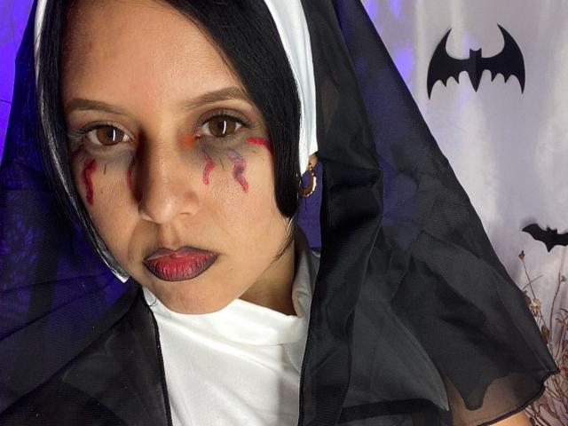 Linger is a Latina nun with dark makeup, red claw marks on her cheeks, black and white habit, and purple eyes. She has red lipstick and a serious expression.