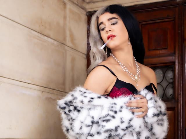 AliceCoolenk with black and blonde hair, red lipstick, pearl necklace, black lace bra, white and black fur coat, cigarette in mouth, eyes closed, holding coat, sexy.