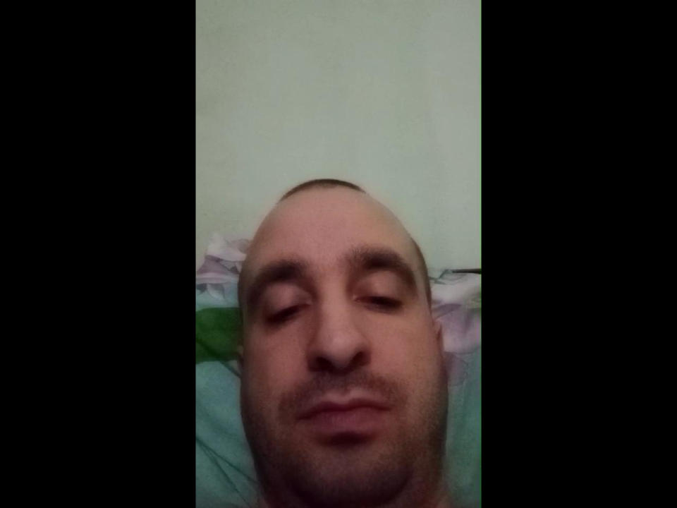 GoldenTime's bald head with closed eyes and a slight smirk, showing a relaxed facial expression. He has a light skin tone and a small amount of facial hair.