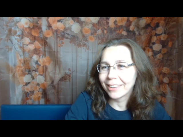DaisyEdit has wavy brown hair, glasses, and a smiling face with a slight open-mouth, wearing a black shirt, in a photograph. Her ass is not visible.