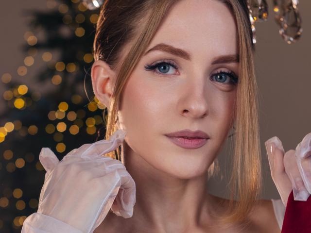 EvaDaly with blue eyes, blonde hair in a braid, wearing white gloves, looking at the camera, slight smile, bokeh lights in the background, soft makeup, pink lipstick.