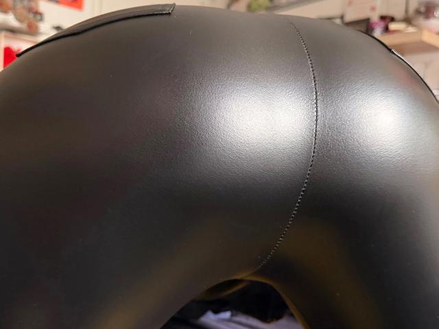 Sophiesoreal77-hot's shiny black leather ass, showing a smooth, glossy texture with visible stitching lines. The photo focuses on the curved, upper part of their buttocks.