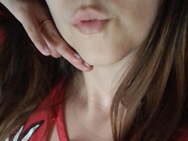 ImFireMoon's pouty lips are slightly parted, with her hand resting gently on her cheek. She's wearing a red top, and her brown hair is partially visible.