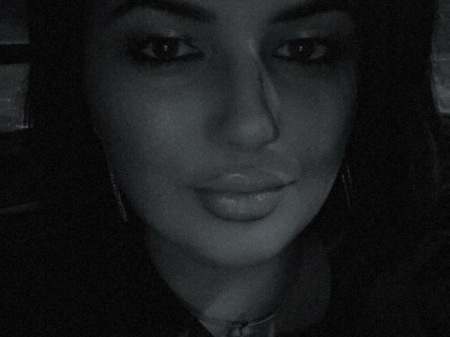 YnnaForU's face in a grayscale photo, showing her pouty lips, slightly upturned nose, and dark, thick eyebrows. Her eyes are looking directly at the camera.