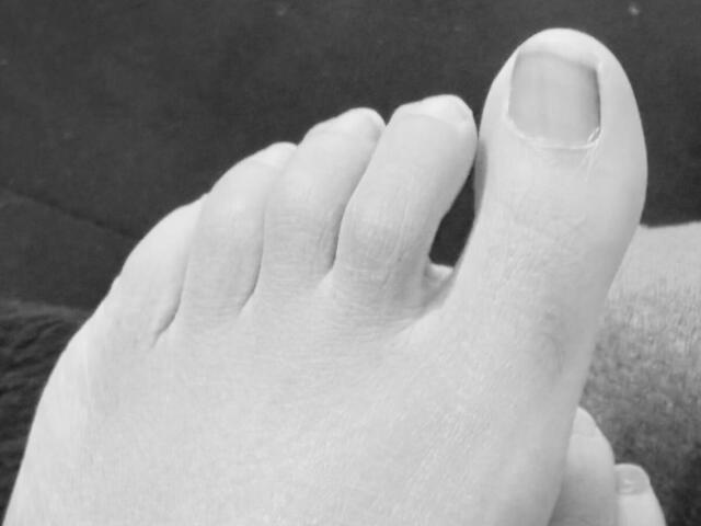 JulieSweety69's bare, slightly dirty foot with a visible big toe and clean toenail, showing some texture and a small crease between toes.