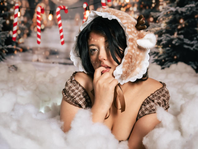 MisakiWong with cute brown reindeer hat, showing off her tits in a fluffy white snow setting, biting her finger, wearing a plaid off-shoulder top, looking sexy.