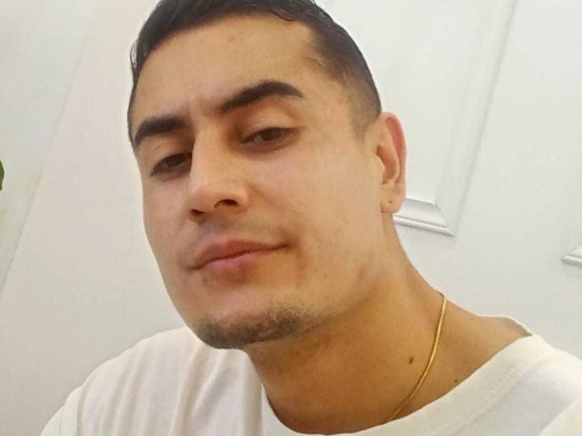 ErickGarciax has a light brown face with short black hair, thick eyebrows, a slight smile, and a gold necklace. He's wearing a white shirt.