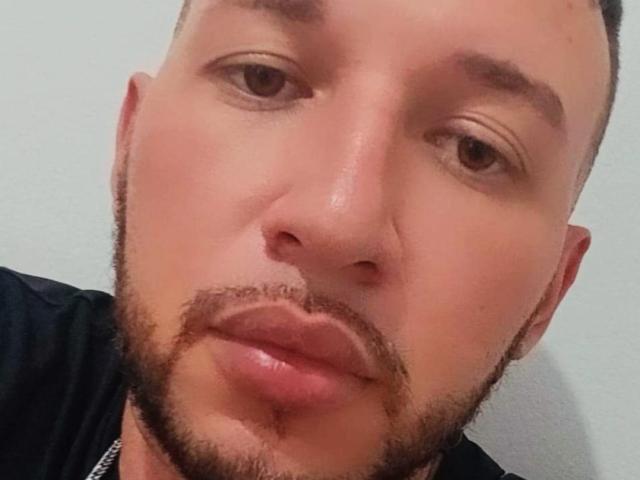 ViggoD's face, showing a short brown beard, slightly parted lips, and a neutral expression, with a close-cropped hairstyle and light skin. His eyes are slightly downcast.