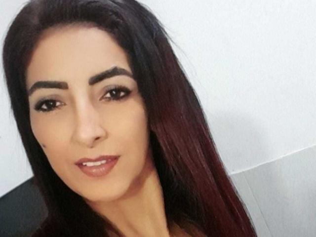 SamanthaXRossie has dark brown hair, thick eyebrows, and full lips with pink lipstick. She's smiling slightly with brown eyes and a light skin tone.