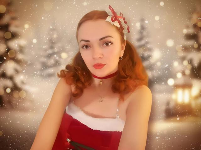 MarcilinCutie with red hair, wearing a Santa dress with white fur trim, red choker, and Christmas headband, has cute tits, fair skin, and red lipstick, in a snowy scene.