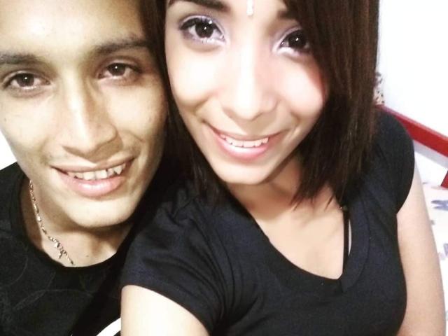 AlejoyMaria with medium brown skin, brown eyes, and black shirt, smiling next to AlejoyMaria with light brown skin, dark brown eyes, black shirt, and white forehead dot.