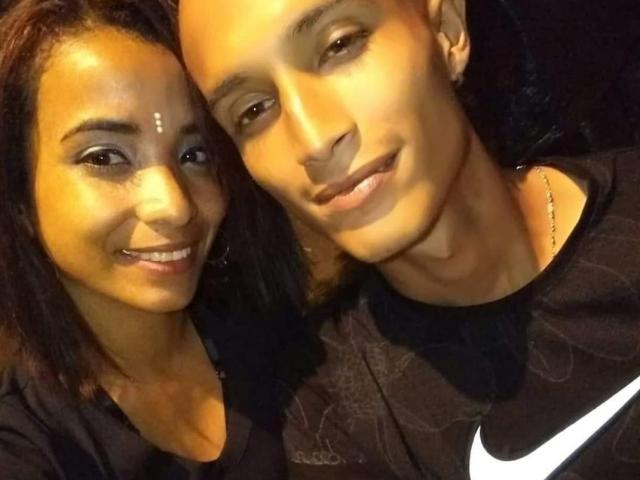 AlejoyMaria with brown skin and black hair, smiling, wearing black shirt. AlejoyMaria with brown skin, bald, black shirt, Nike logo, smiling, dark background, both close.