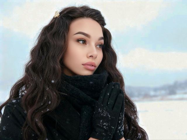 Niferttiti has wavy dark brown hair, wearing a black scarf and gloves, snow on her face, looking to the side, with a soft, attractive, and cute expression.