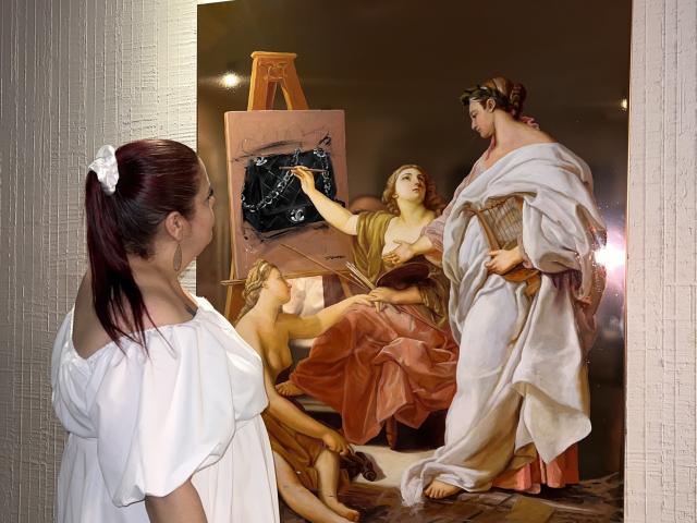 VanesaMoka with red hair in white dress, looking at classical painting of three women, one with tits raised, another with ass up, and a third with large tits.