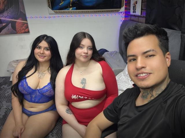 IssaLunaCrinst in blue lace bra and panties, IssaLunaCrinst in red cutout dress, and IssaLunaCrinst in black shirt, smiling, tattoos visible, bedroom, selfie.