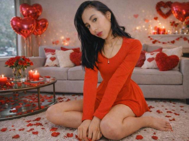 DaphneSpencer, Asian girl, sitting on white carpet, knees up, wearing red dress, black hair, red lipstick, red candles, red heart balloons, red rose petals, cute, sexy.