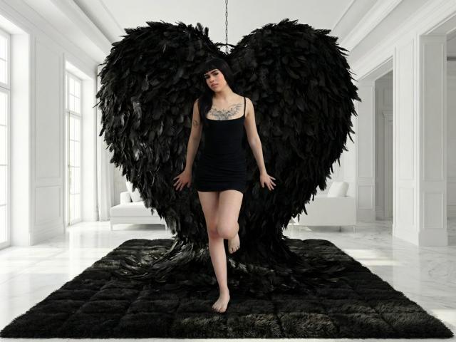 HannaMitsury with huge black feathered wings, black dress, tattoo on chest, standing barefoot on black rug, white room, looking down, wings shaped like heart, wings attached to floor.