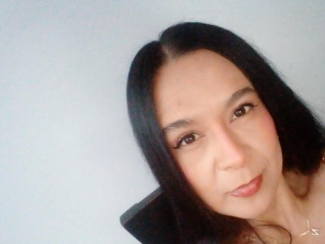AileenRamirezW with straight black hair, brown eyes, and light skin, has a slight smile and is looking at the camera, showing her face and upper chest.