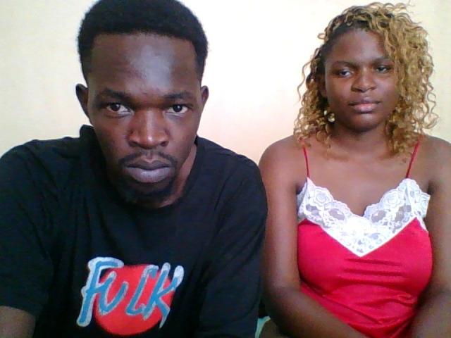 ThearoMuse is a dark-skinned man with short black hair and a serious expression, wearing a black shirt with "Funk" on it. ThearoMuse has a dark-skinned woman with curly blonde hair.