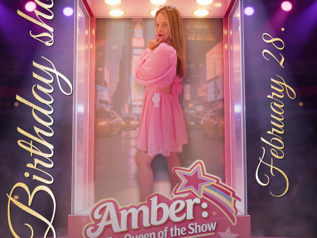 AmbeerWood with long blonde hair, wearing a pink, off-shoulder, heart-patterned robe, standing in a glass case, looking back with a hand on her chin, showing her ass.