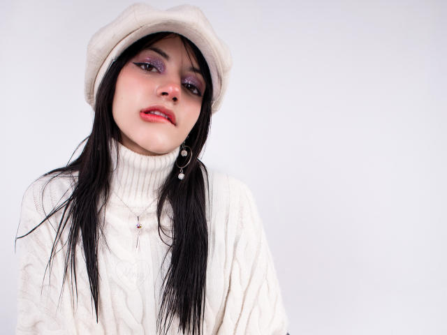 Digital artwork of DafneRivas, wearing a white turtleneck and white beanie, with long black hair, purple eyeshadow, and red lipstick. High contrast, stark white background, intense gaze, slight tilt.