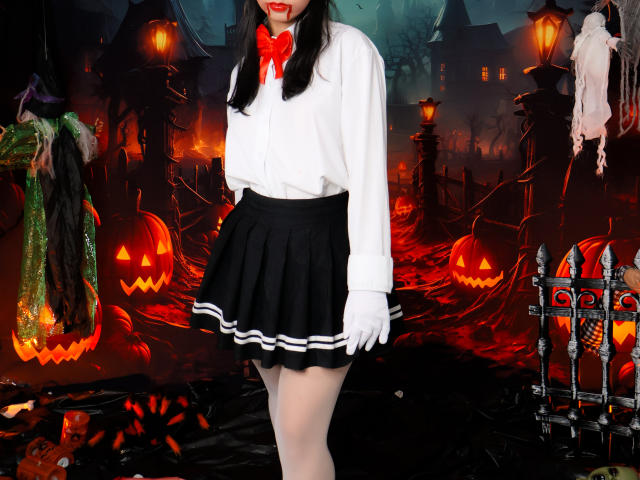 Digital artwork of ZoeWinfrey in a white blouse and black skirt, standing in a dark, Halloween-themed scene with glowing orange jack-o'-lanterns, red ribbons, and eerie street lamps. Her legs are exposed.