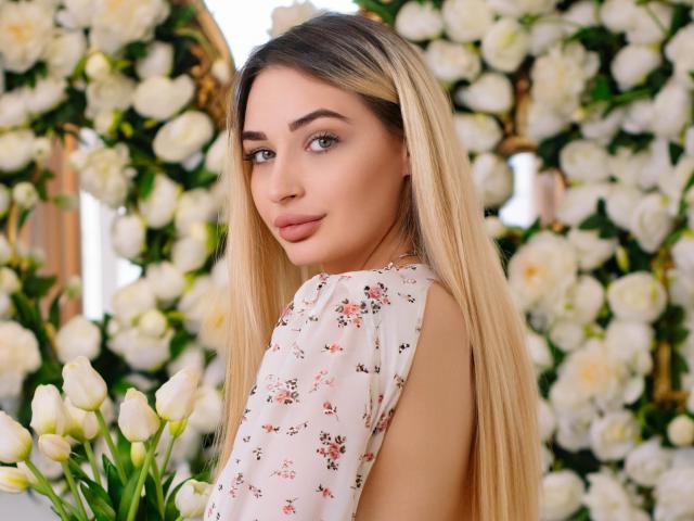 BarbaraRosy, cabello rubio largo, vestida con un vestido blanco con flores, mirando por encima del hombro, sonrisa suave, ojos azules. rodeado de tulipanes blancos y rosas, tensión sexual, sexy, colores vibrantes, fondo detallado..