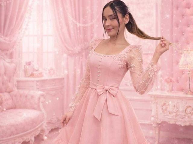 Digital portrait of MindyLove with brown hair in a ponytail, wearing a pink lace dress with a bow, holding her hair, standing in a softly lit, pink, ornate room. Fucking sexy.