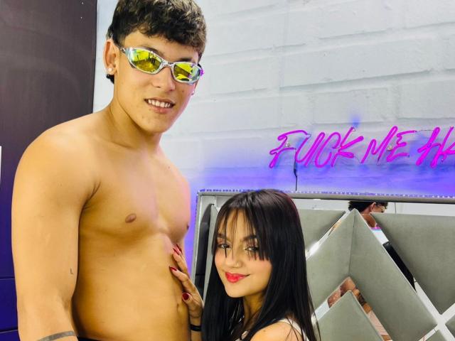 EndlessTwo, a shirtless man with curly brown hair and reflective sunglasses, stands with his hand on his bare chest. Next to him, EndlessTwo, a woman with long black hair, smiles.