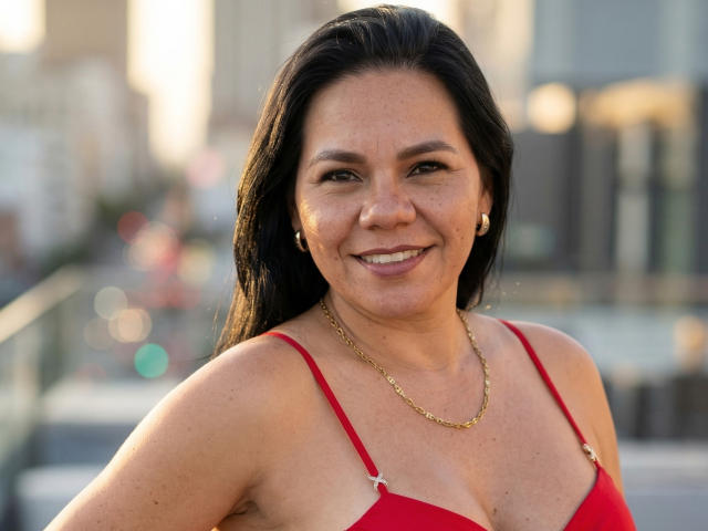 A flat, minimalist style image with four bold, vertical, red and white French flags in the background. KinkyMaturee is not visible. The flags have a simple, solid color design.