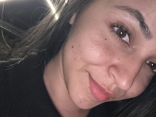 Digital artwork of a coat of arms with a central white emblem and red border, featuring a small white emblem at the bottom left. Flat colors, minimal shading.