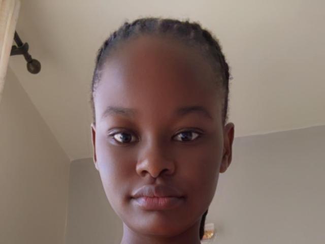 Close-up of a coat of arms with a white, red, and black design. Simple, bold shapes with a central white rectangle and red borders. Clean, minimalist style.
