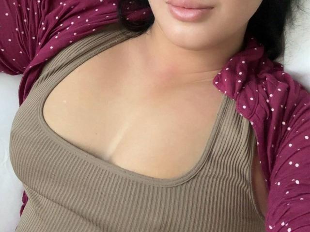 Minimalist design with a large, abstract, pinkish-beige shape centered. Four small red dots on each side. Vertical lines on the bottom. Simple, modern aesthetic.