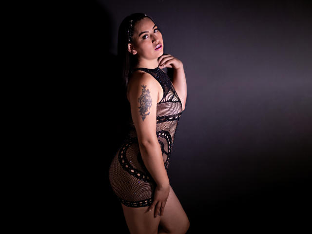 A digital illustration of a heraldic coat of arms with a red shield, a central white rose, and a black and red lion passant. The shield has a subtle, reflective texture.