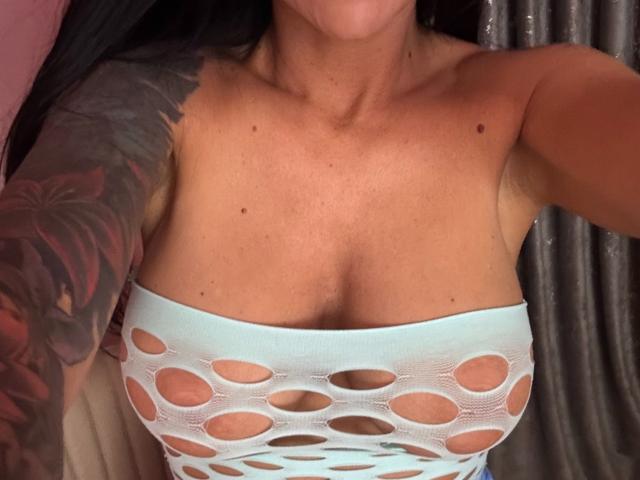 A minimalist digital illustration of a stylized, bold, red and white coat of arms. The coat features a central red square with a white cross, flanked by smaller red and white squares.