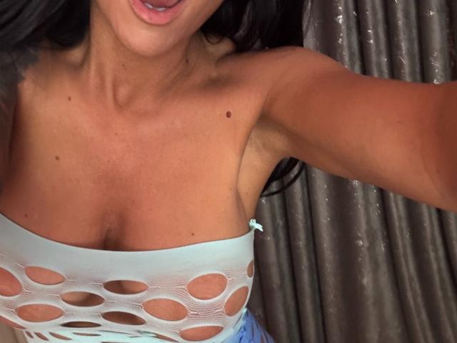 A digital illustration of a coat of arms with a bold, red center and white, vertical cross. AndraD's coat of arms has clean, sharp lines and a minimalist design.