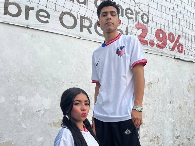 TheInnocentOfSnake, a tall dude with short curly brown hair, wears a white soccer shirt with pink trim and black shorts. TheInnocentOfSnake, a cute girl with long black hair.