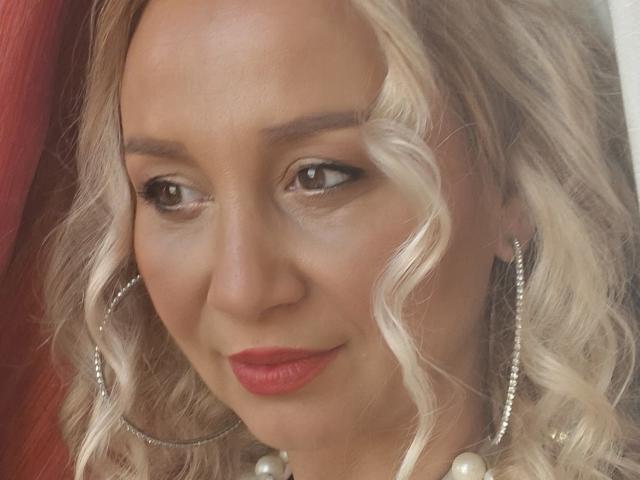 Flat, stylized coat of arms with a bold, red center. Four identical, white, vertical stripes on each side. Simple, symmetrical design. Minimal shading and detail. Modern, graphic style.