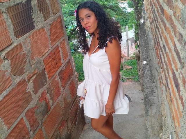 A digital illustration with a red and white emblem in the center, surrounded by green textured patterns. The emblem is bold with a white star in the lower right.