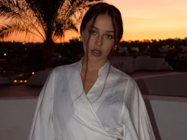 Digital art of a Soviet-era hammer and sickle with a glowing orange light behind it. Simple, bold colors with a focus on the hammer and sickle symbol. Clean lines.