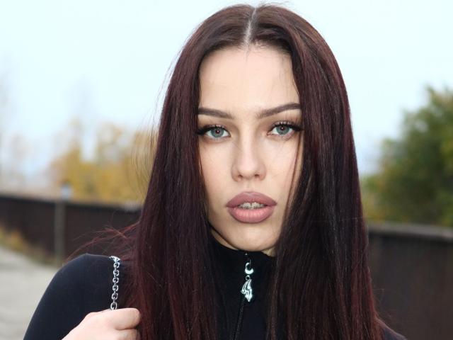 Simple, flat-style illustration of a Japanese-style crest with a central circle and curved lines, in soft, muted colors. Crest is centered, with subtle shadows adding depth. Minimalistic design.