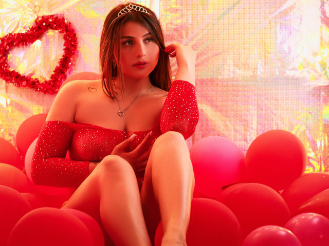 A bunch of Asian-style paper fans with red and black accents, arranged in a slightly overlapping pattern. Soft, muted colors and subtle textures. SaraWestt not visible.