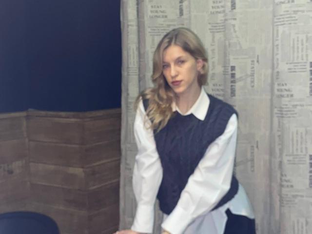 Digital art of a white, stylized coat of arms with a red flame-like design in the center. Simple, bold colors. Flat, minimalist design. DeedraGalarneau's coat of arms. Clean, modern look.