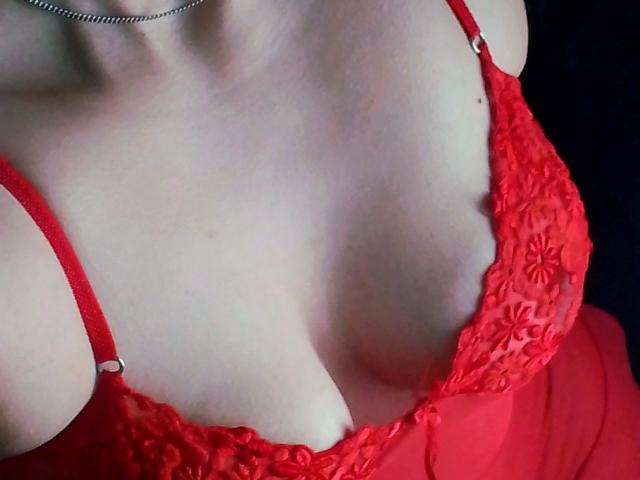ImFireMoon's tits in a red lace bralette, showing ample cleavage, with thin straps and a silver chain necklace. The focus is on her chest and upper torso.