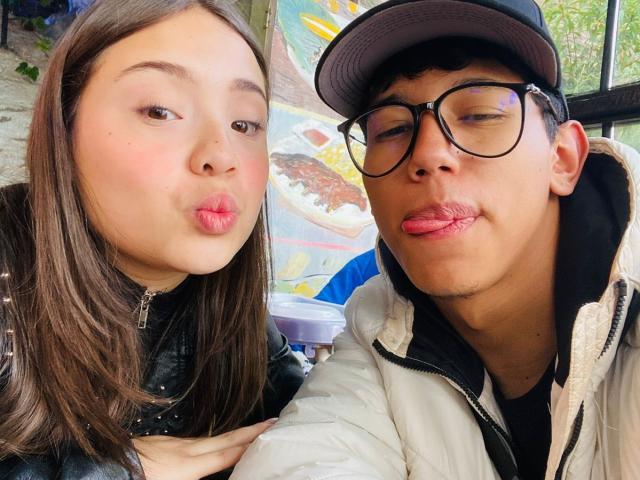 RyanNPricee with puffy pink lips, brown hair, black jacket, next to RyanNPricee with puffy pink lips, glasses, black cap, white jacket, black hoodie.