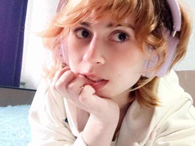 MireilleSpotwood with pink headphones, pale skin, blonde messy hair, and a cute face, biting her finger, wearing a white hoodie, looking up with big eyes.